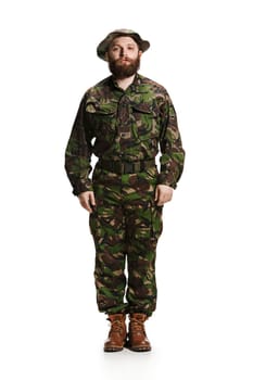 Young army soldier wearing camouflage uniform isolated on white studio background in full-length. Young caucasian model. Military, soldier, army concept. Proffeshional concepts