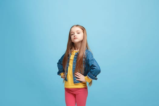 Serious doubtful, thoughtful teen girl remembering something. Young emotional woman. Human emotions, facial expression concept. Studio. Isolated on trendy blue. Front