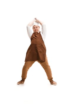 Angry aggressive butcher swinging with a knife isolated on white studio background. The young caucasian male model in full-length. Butcher, knife, professional concept