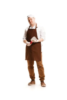 Smiling butcher posing with a cleaver isolated on white studio background. The young caucasian male model in full-length. Butcher, knife, professional concept