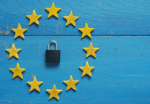 European Union sign with a padlock on a blue rustic wooden background, DSGVO concept image
