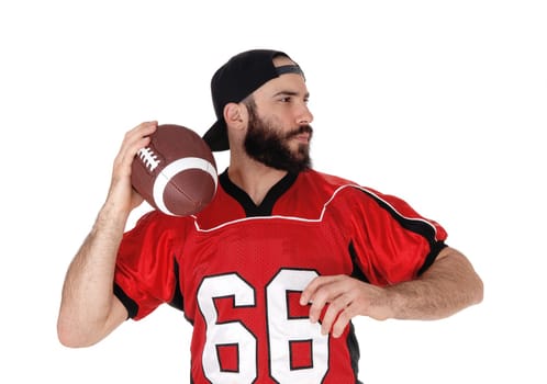 An American football player standing with his ball in his hand in a .close up image, with a beard and mustache, isolated over white.