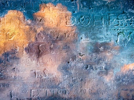 Engraved writings on colorful stone wall