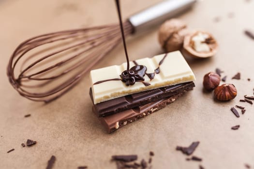 Variety of delicious chocolate bars with melted chocolate