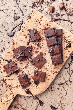 Delicious dark chocolate pieces with cocoa powder