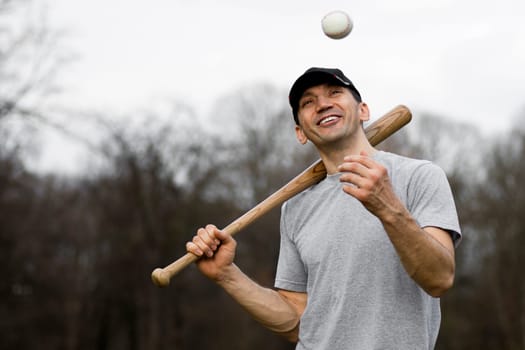Portrait of cheerful smiling baseball player outdoors.