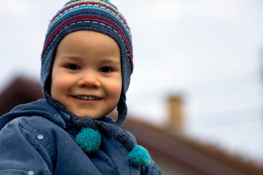 Portrait of smiling little boy outdoors, look at camera.