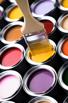 Colorful paint cans with paintbrush