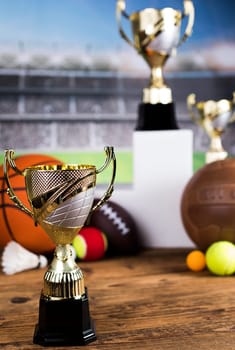 Cups of winners award on white podium, sport background