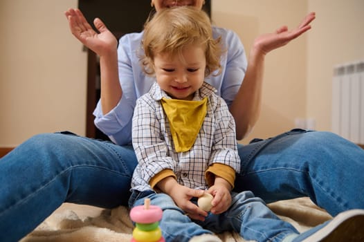 A joyful moment between a mother and her toddler child, spending quality time together indoors, reflecting familial love and connection.