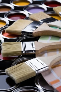 Metal tin cans with color paint and paintbrush