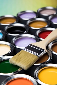 Tin metal cans with color paint and paintbrush