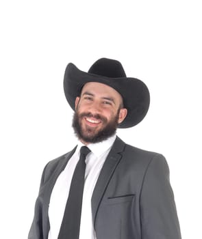 A close up portrait image of a handsome man in a suit and cowboy hat.with a beard and mustache, smiling, isolated for white background.