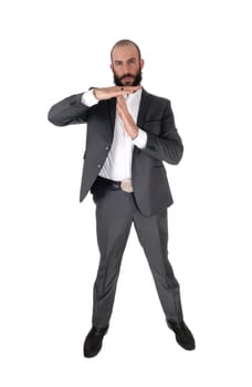 A young tall businessman standing in a suit with a beard and signing.he wants to talk, isolated for white background.
