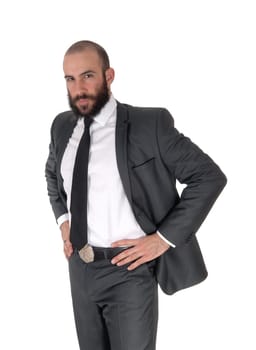 A handsome young businessman standing in a suit and tie with his.hands on his hips, with a beard, isolated for white background.