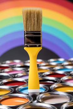 Metal tin cans with color paint and paintbrush