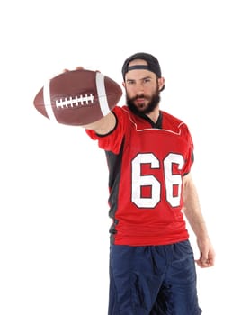 A young football player standing in his uniform and a beard and .mustache ready to throw his football, isolated for white background.