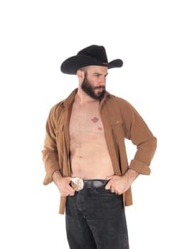 A close up image of a young man in a open brown shirt wearing a.cowboy hat and black jeans, isolated for white background.