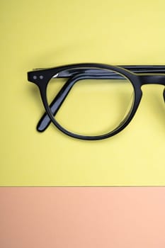 black glasses on yellow and orange ground from above
