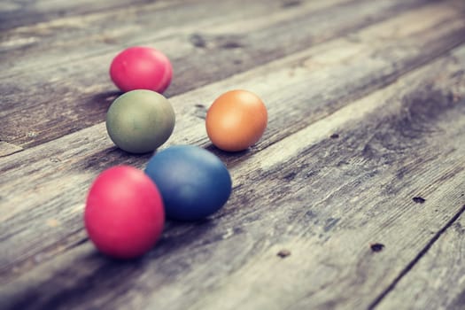 different easter eggs on gray wooden ground