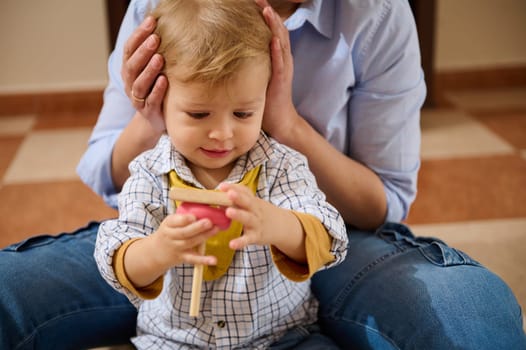 A mother lovingly engages with her young child, encouraging play and exploration. Ideal image for concepts of parenting, family, and emotional bonds.