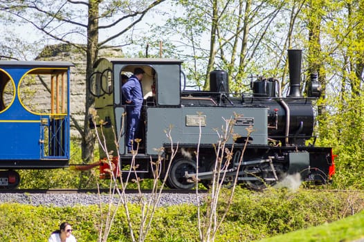 Pairi daiza,Belgium,Europe-19/04/2018.Departure of a steam locomotive in a cloud of smoke and steam in an animal park in North West Belgium