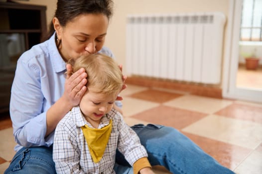 A mother lovingly interacts with her young child, creating a warm and tender family bond at home. Captures the emotional connection and joy of parenting.