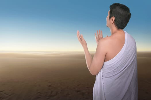 Religious asian hajj man praying with blue sky background