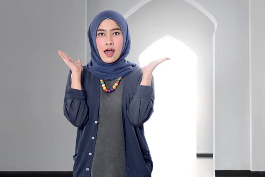 Funny asian female muslim woman with hijab on the mosque
