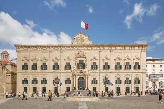 VALLETTA, MALTA - OCTOBER 30, 2017: People walking in front of the office of the prime minister of Malta, former building of The Auberge de Castille in Valleta, Malta.