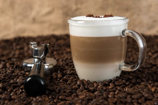 Latte Macchiato with heart on coffee beans