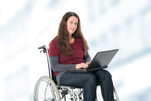 young woman in wheelchair working with the computer