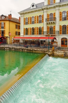 Annecy, France - May 01, 2018: Medieval old town and the tower of Palais de l'Isle castle on Thiou river in Annecy, Savoy, France