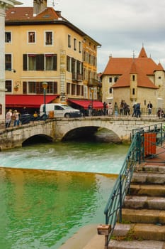 Annecy, France - May 01, 2018: Medieval old town and the tower of Palais de l'Isle castle on Thiou river in Annecy, Savoy, France