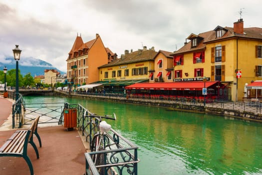 Annecy, France - May 01, 2018: Medieval old town and the tower of Palais de l'Isle castle on Thiou river in Annecy, Savoy, France