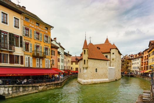 Annecy, France - May 01, 2018: Medieval old town and the tower of Palais de l'Isle castle on Thiou river in Annecy, Savoy, France