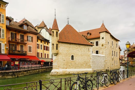 Annecy, France - May 01, 2018: Medieval old town and the tower of Palais de l'Isle castle on Thiou river in Annecy, Savoy, France