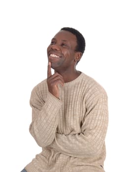 A young handsome African American man sitting in a sweater with.one finger on his chin, smiling of success, isolated over white.