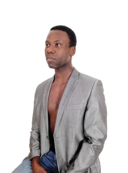 A handsome young African American man sitting in a gray blazer.looking away, waist up, isolated for white background.