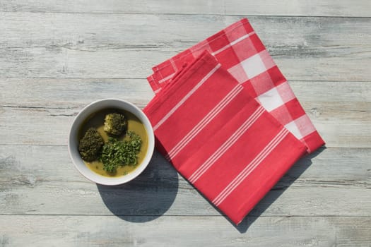 Healthy broccoli soup homemade with parsley. Health concept. Top view outdoor.