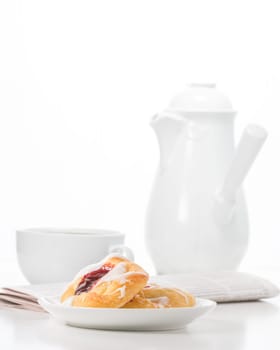 Breakfast consisting of raspberry danish and coffee.