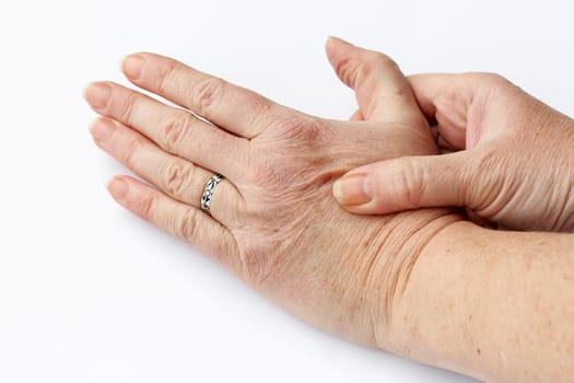 An elderly woman has pain in her hands. Senior citizen with pain in her hand