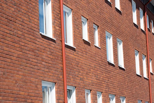 Apartmend building with Windows and bricked wall.