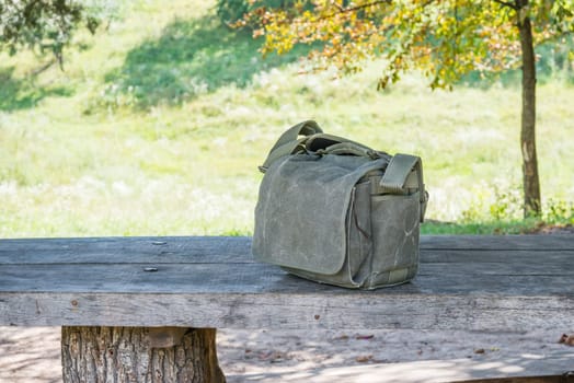 Strong cotton bag for photo stuff isolated on a table in forest