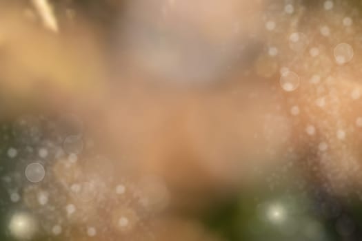Abstract bright brown bokeh background with glittering stars.