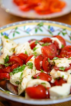 tomato and Mozarella- salad on wooden table