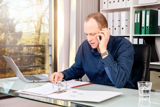 young business man at his desk write