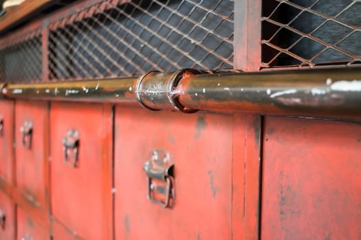 Red metal antique distressed cabinet with door pulls, stock photo