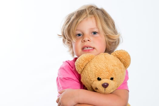 little sweet girl with teddy bear in front of white background