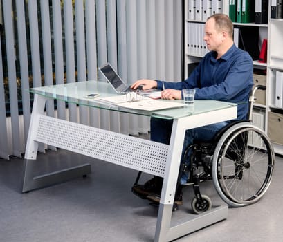 disabled businessman in wheelchair working in the office